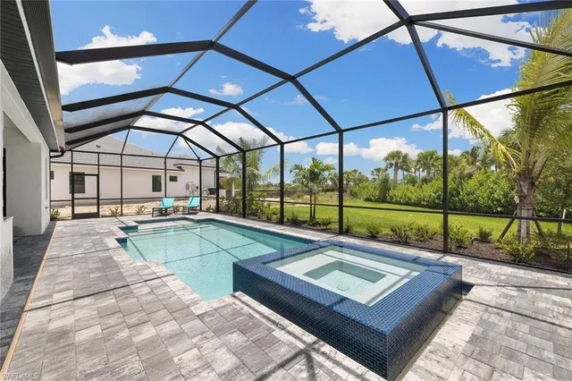 a view of a patio with a table and chairs under an umbrella