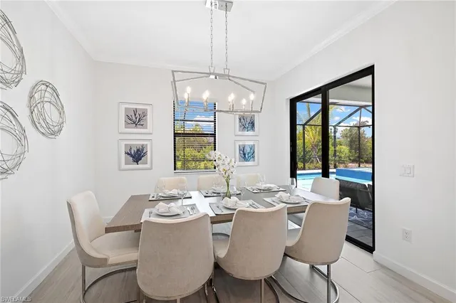 a dining room with furniture a window and wooden floor