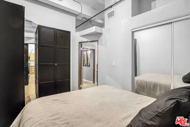 a bedroom with a bed and a mirror