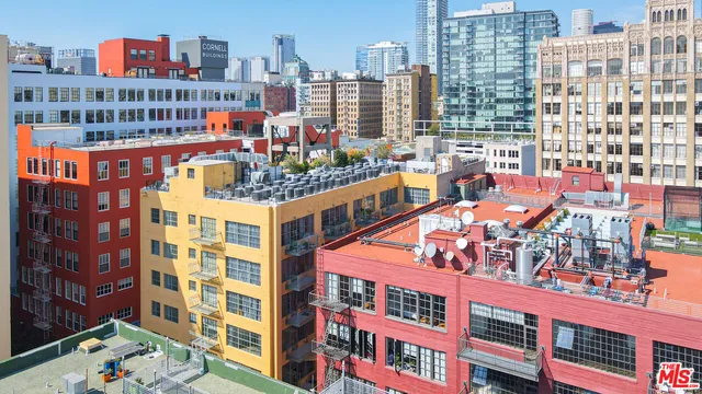 a view of a patio with a table and chairs and potted plants