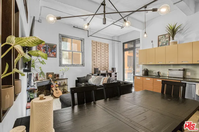 a large white kitchen with lots of counter space and windows