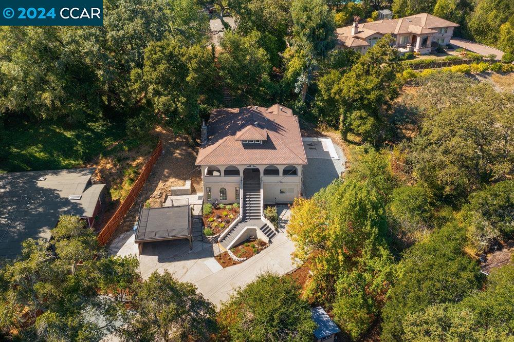 32 El Toyonal Orinda, CA 94563 - Photo 1 of 1 an aerial view of a house with swimming pool and large trees
