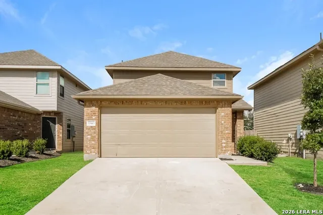 a front view of a house with a yard and garage