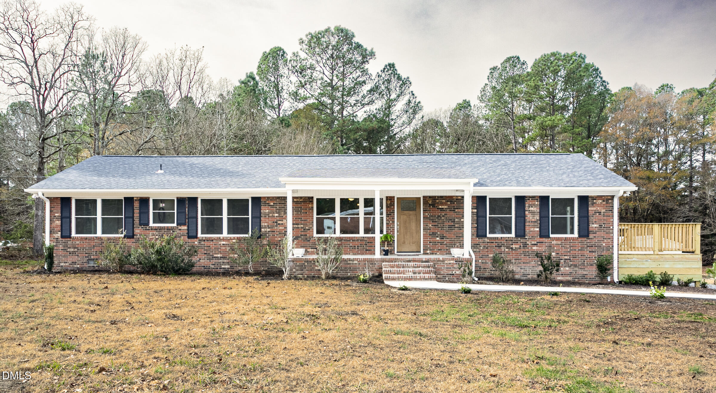 a front view of house with yard space and trees around