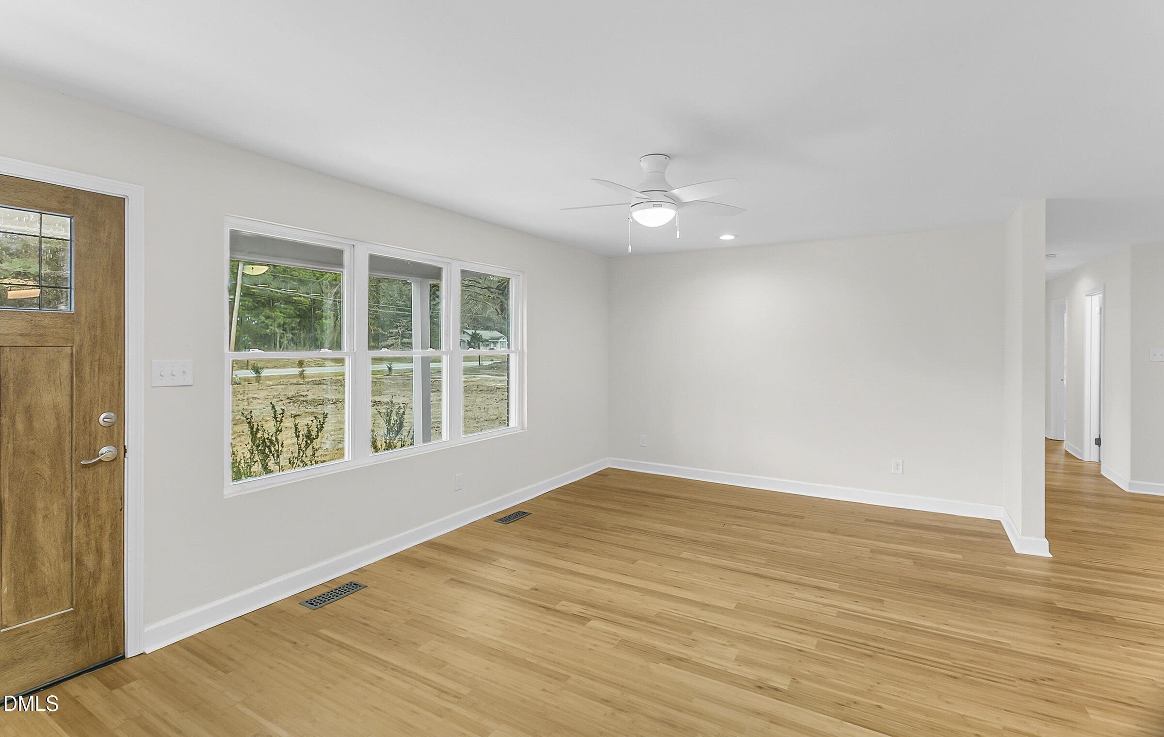 4713 South Nc 87 Graham, NC 27253 - Photo 4 of 35 a view of an empty room with wooden floor and a window