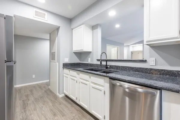a kitchen with stainless steel appliances granite countertop a sink and a granite counter tops