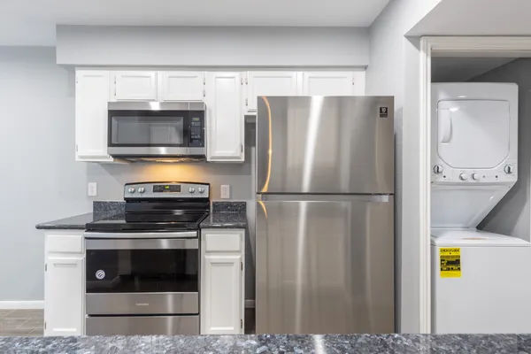 a kitchen with a refrigerator stove and microwave