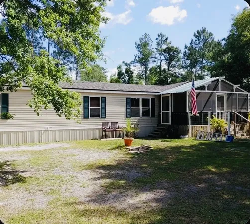 a view of a house with backyard porch and sitting area