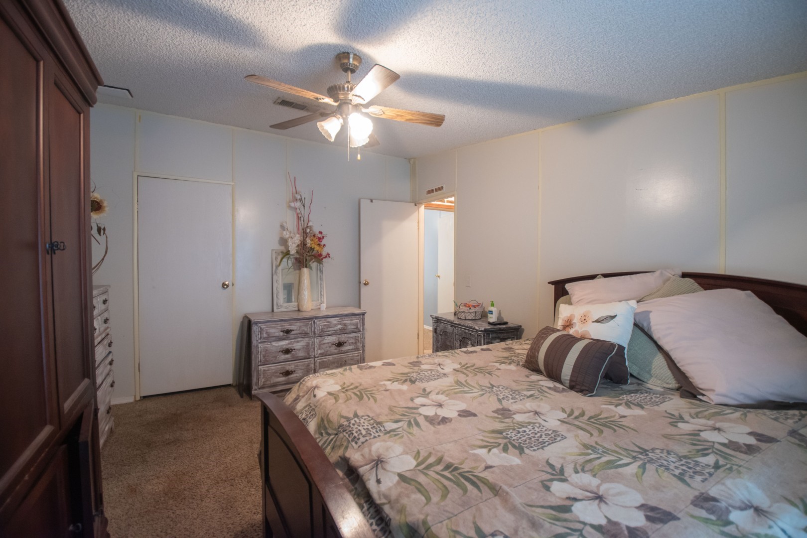 85216 Lina Road Fernandina Beach, FL 32034 - Photo 12 of 47 a bedroom with a bed and a chandelier