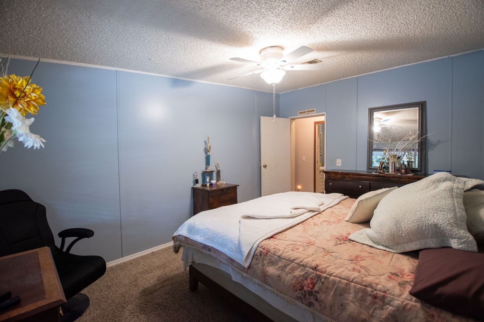 85216 Lina Road Fernandina Beach, FL 32034 - Photo 14 of 47 a bedroom with a bed and a chandelier