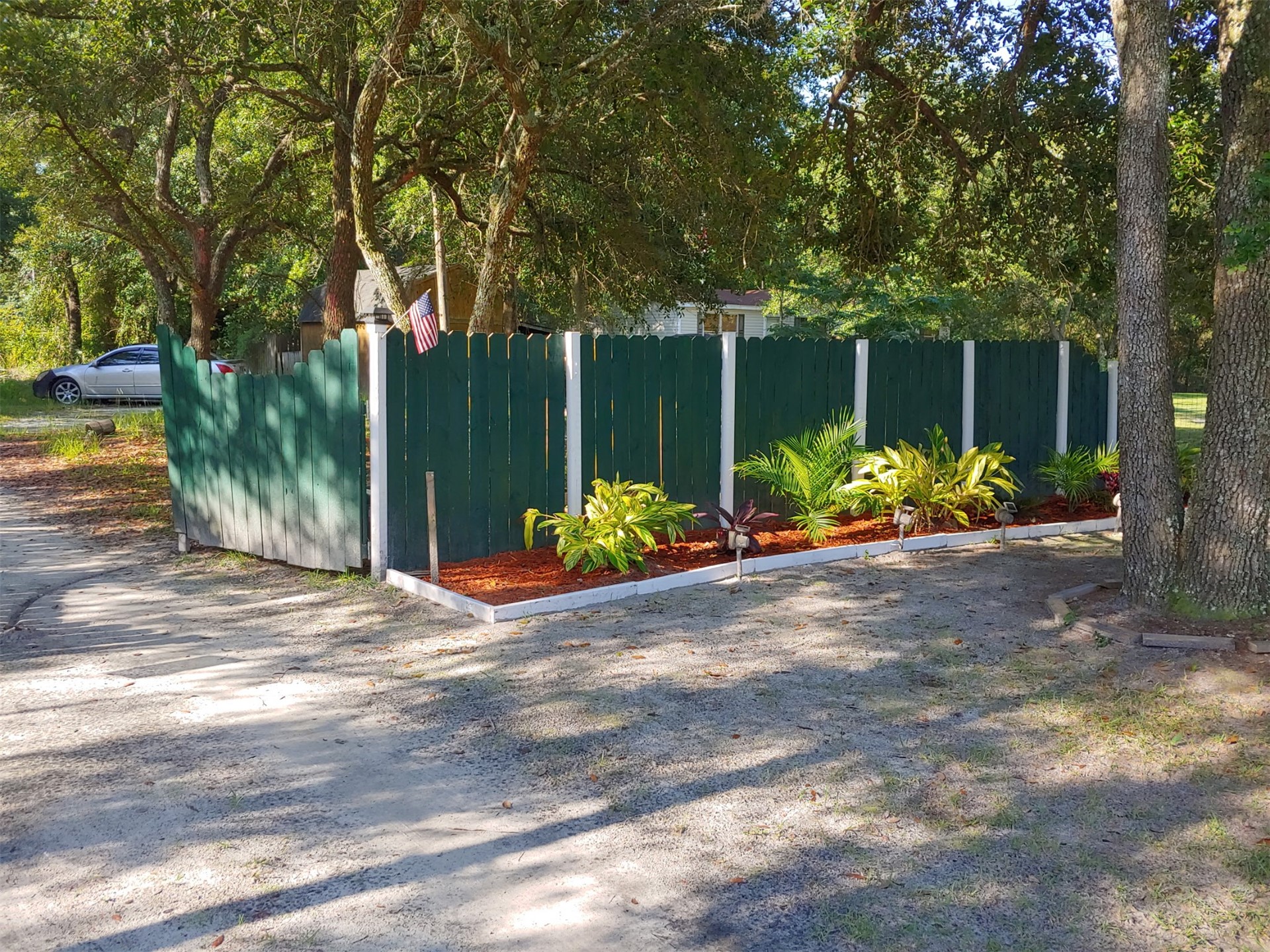 85216 Lina Road Fernandina Beach, FL 32034 - Photo 3 of 47 a view of a bench in back yard of the house
