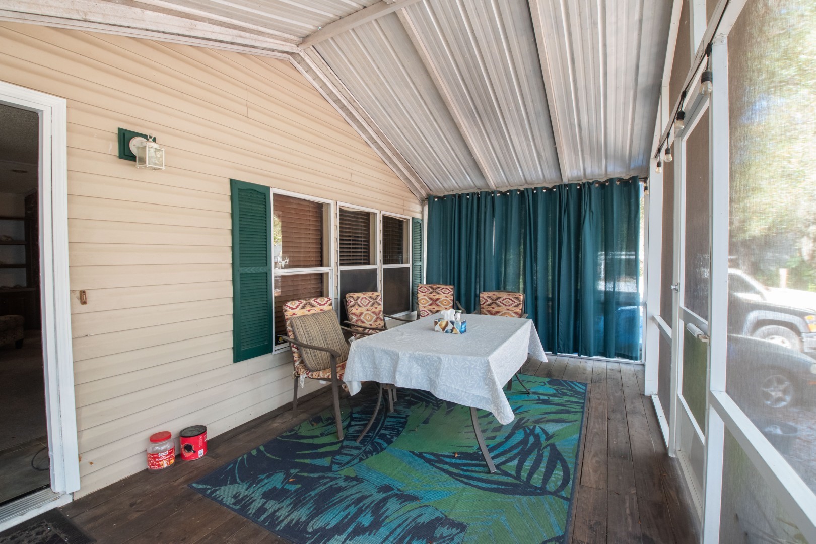85216 Lina Road Fernandina Beach, FL 32034 - Photo 4 of 47 a view of a patio with table and chairs with wooden floor and fence