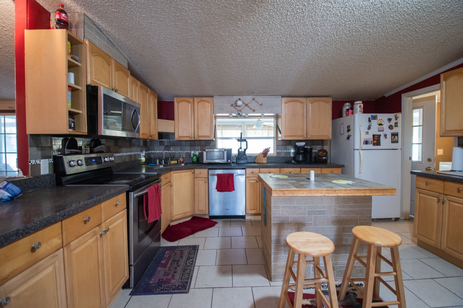 85216 Lina Road Fernandina Beach, FL 32034 - Photo 6 of 47 a kitchen with stainless steel appliances granite countertop a stove sink and cabinets