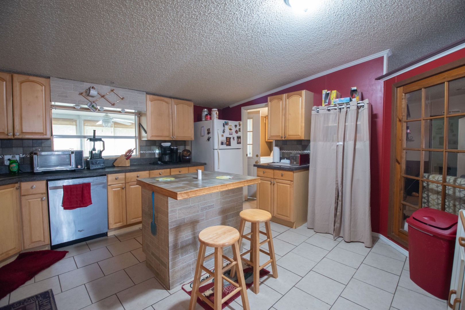 85216 Lina Road Fernandina Beach, FL 32034 - Photo 7 of 47 a kitchen with stainless steel appliances granite countertop a stove a refrigerator a sink a dining table and chairs with wooden floor