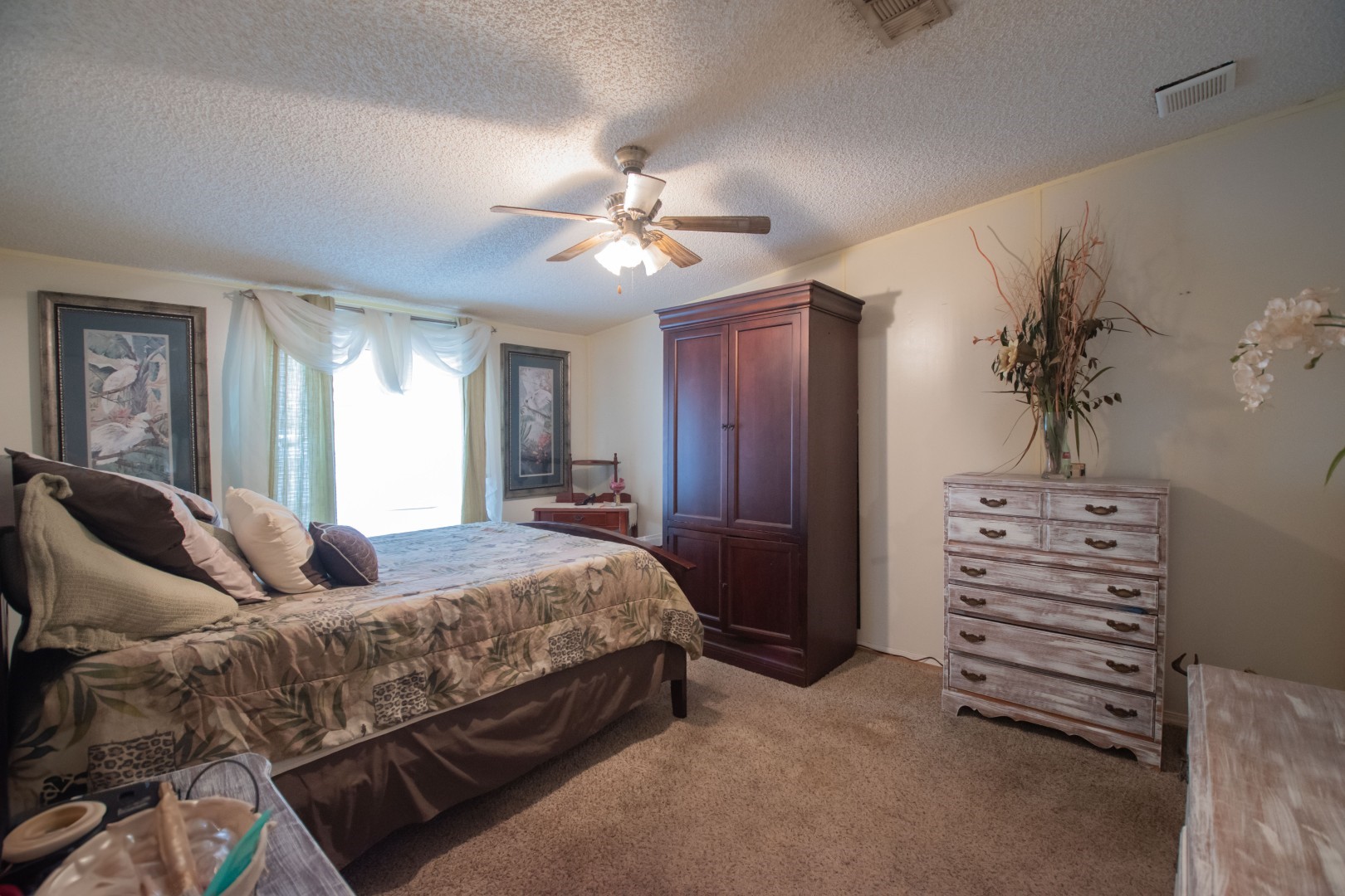 85216 Lina Road Fernandina Beach, FL 32034 - Photo 10 of 47 a bedroom with a bed and ceiling fan