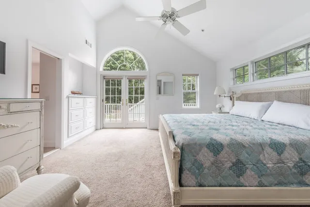 a bedroom with a large bed mirror and furniture