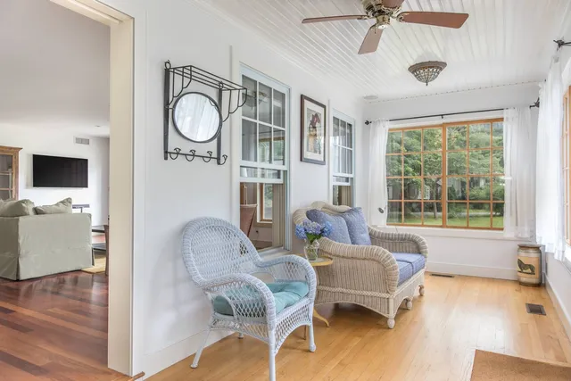 a living room with furniture a flat screen tv and a window