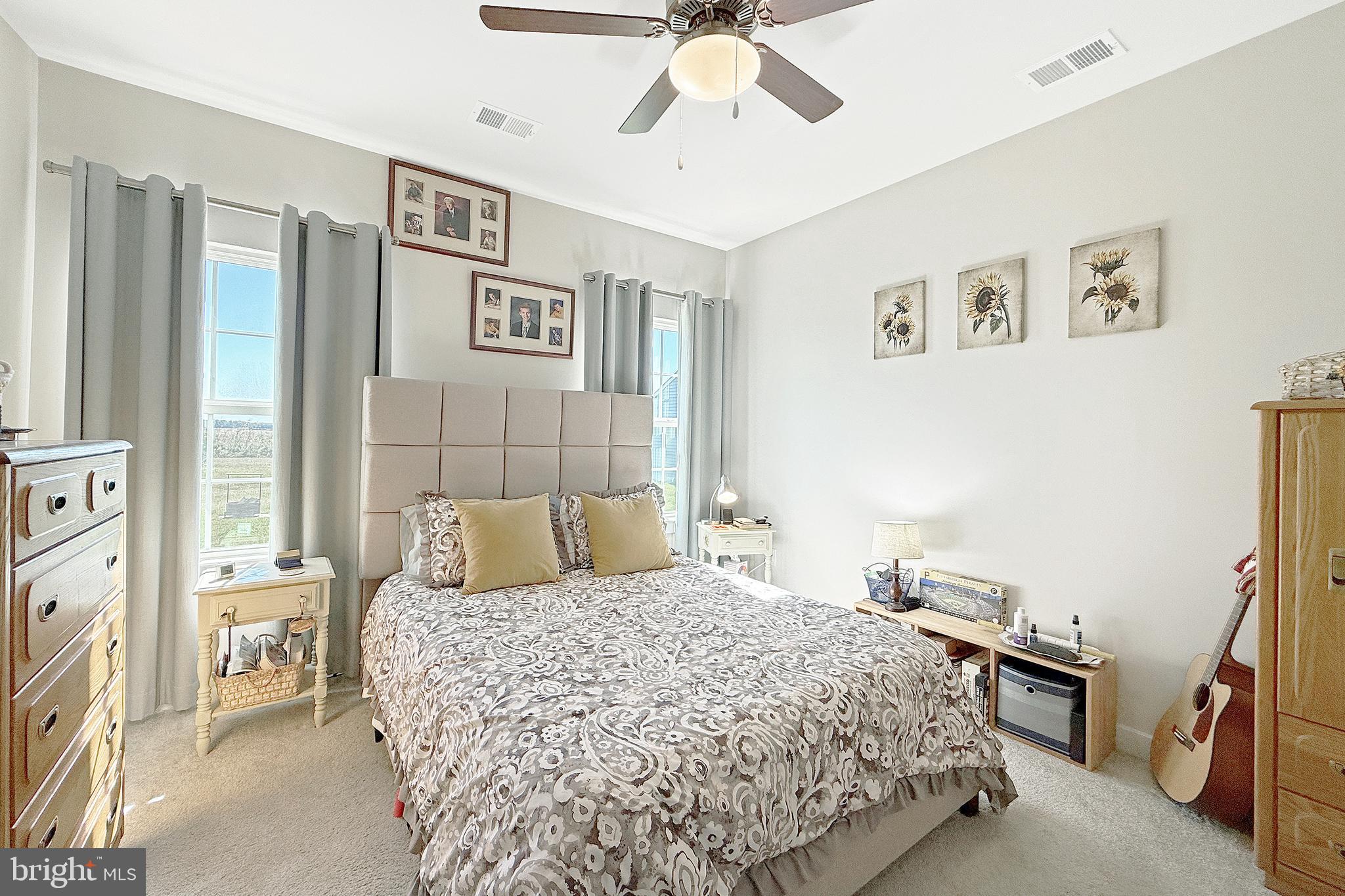 24901 Long Cove Court Millsboro, DE 19966 - Photo 14 of 23 a bedroom with a bed and a chandelier