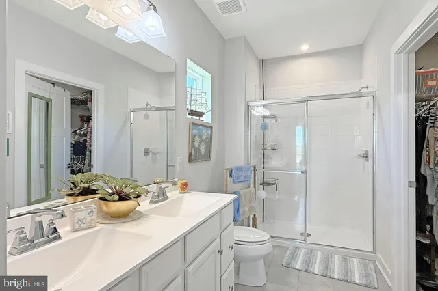 a bathroom with a sink toilet a mirror and shower