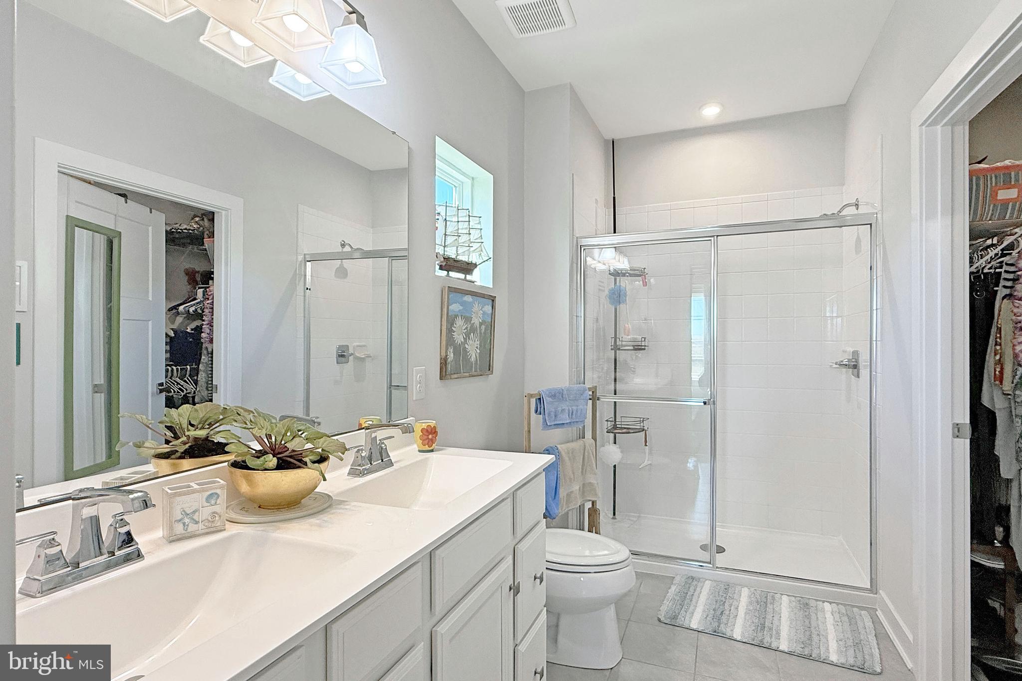 24901 Long Cove Court Millsboro, DE 19966 - Photo 15 of 23 a bathroom with a sink toilet a mirror and shower