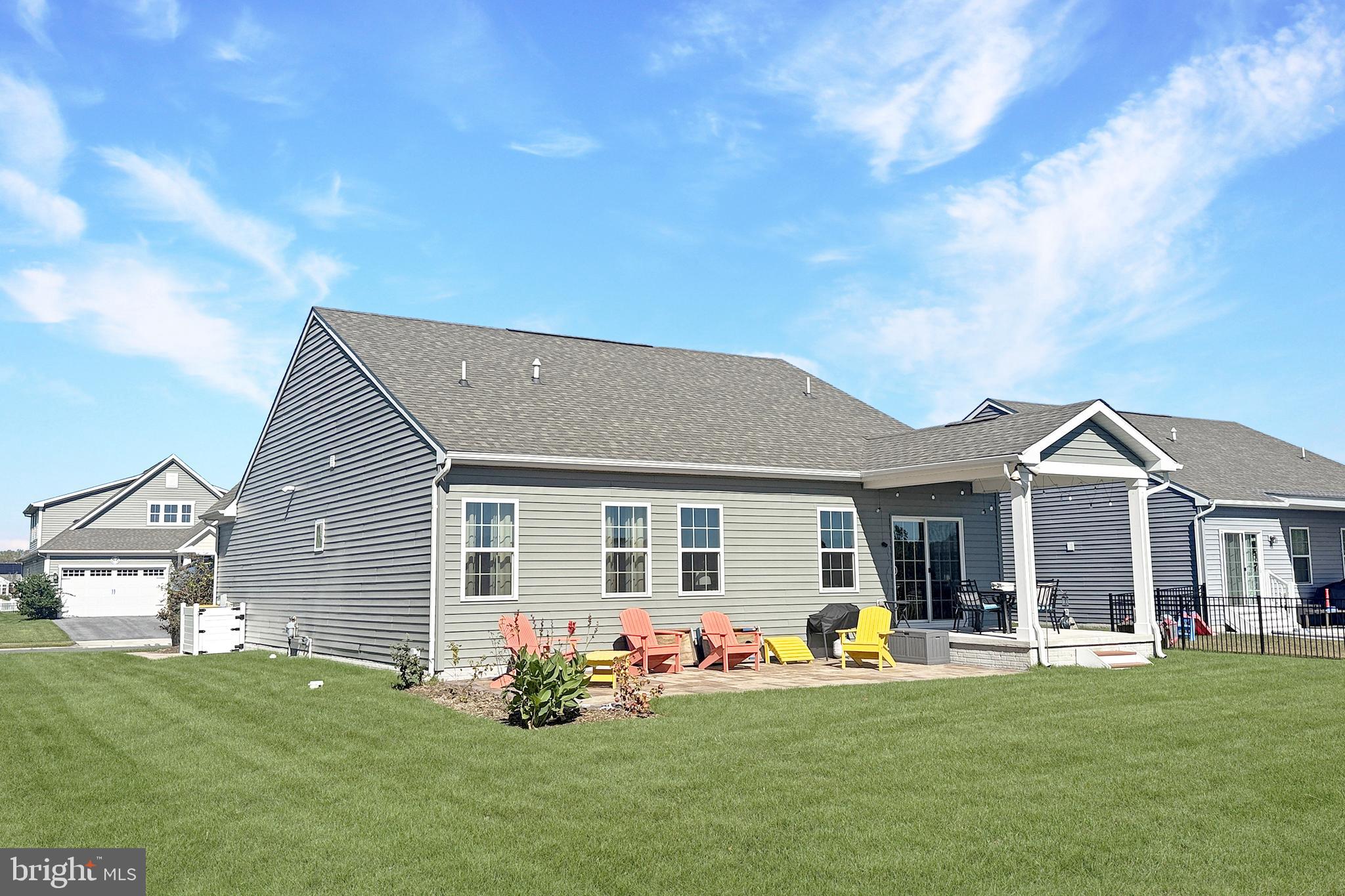 24901 Long Cove Court Millsboro, DE 19966 - Photo 18 of 23 a front view of house with yard barbeque and outdoor seating