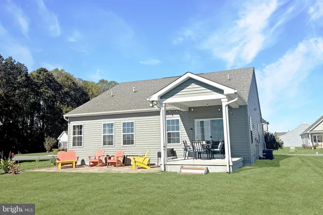 a front view of house with yard outdoor seating and green space