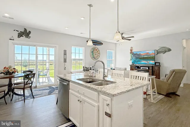 a very nice looking living room with a large dining table and a wooden floor