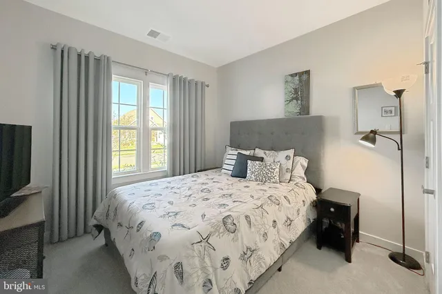a bedroom with a bed and a tv on table