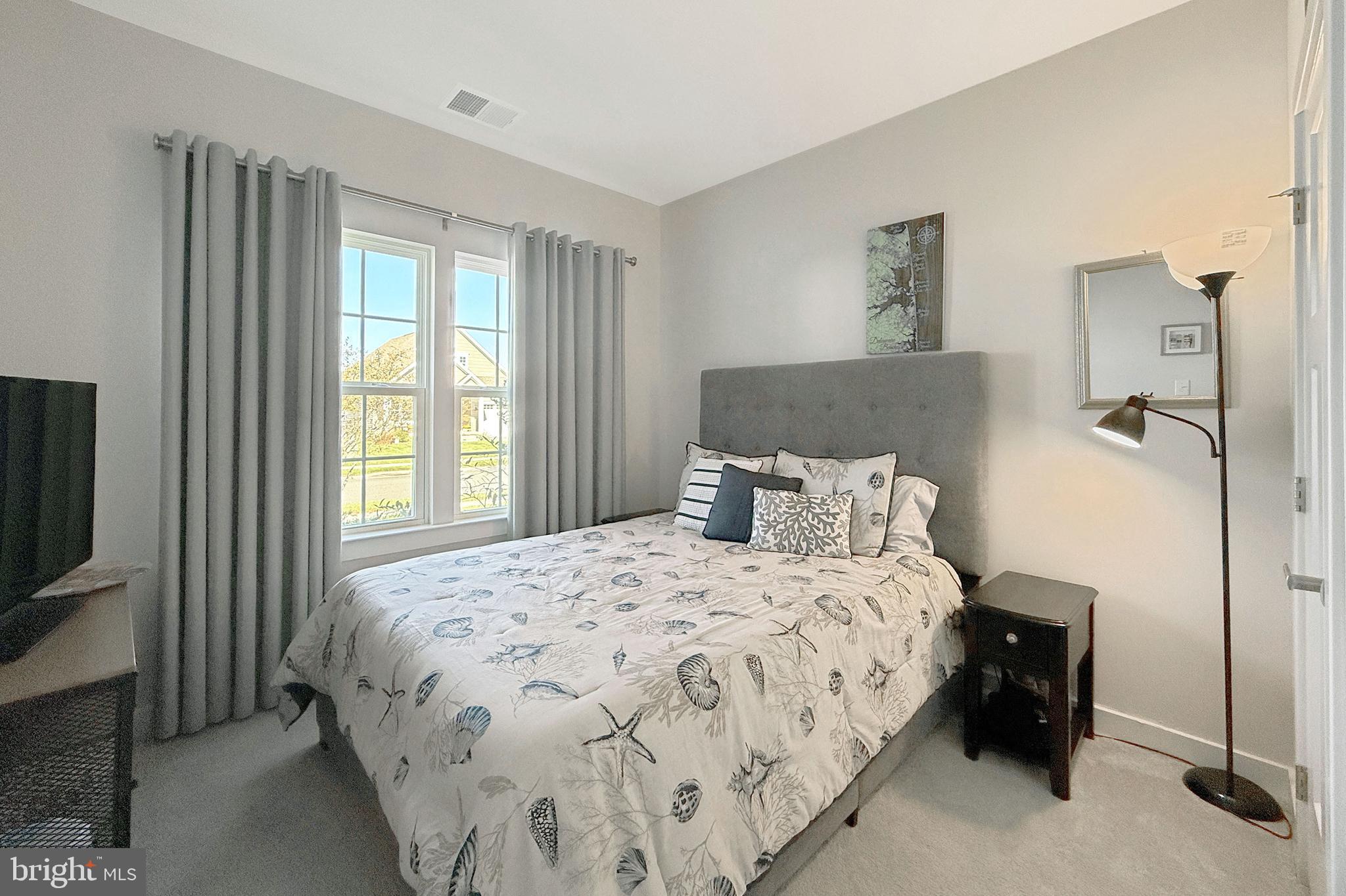 24901 Long Cove Court Millsboro, DE 19966 - Photo 10 of 23 a bedroom with a bed and a tv on table