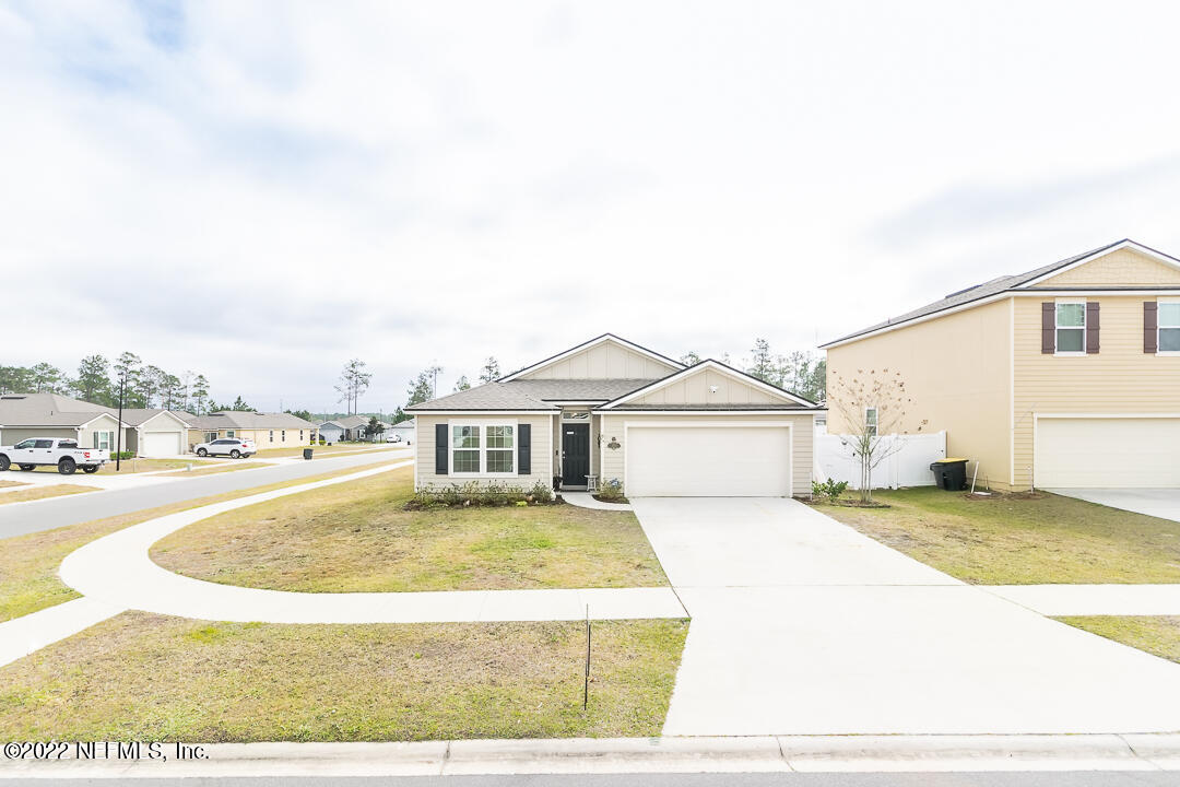 3807 Bronco Road Middleburg, FL 32068 - Photo 11 of 25 a view of a house with a yard and garage