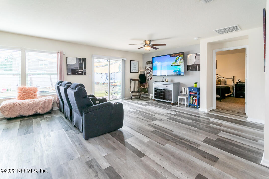 3807 Bronco Road Middleburg, FL 32068 - Photo 3 of 25 a living room with furniture and a flat screen tv