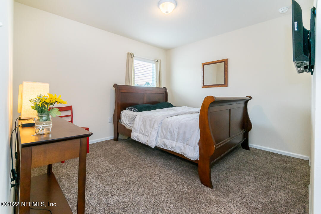 3807 Bronco Road Middleburg, FL 32068 - Photo 9 of 25 a bedroom with a bed and a flat screen tv