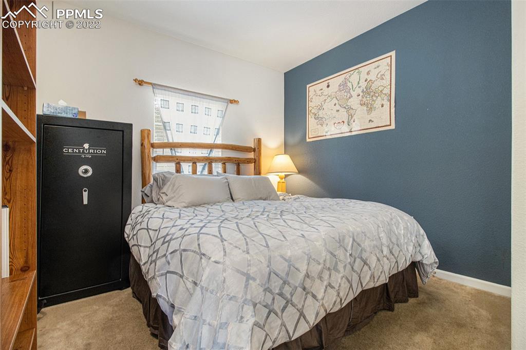 1472 Thunder Butte Road Castle Rock, CO 80109 - Photo 5 of 10 a bedroom with a bed and window