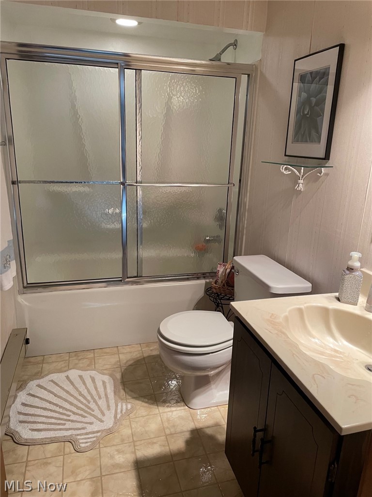 3100 Station Road Medina, OH 44256 - Photo 11 of 15 Full bathroom with tile floors, toilet, and bath / shower combo with glass door