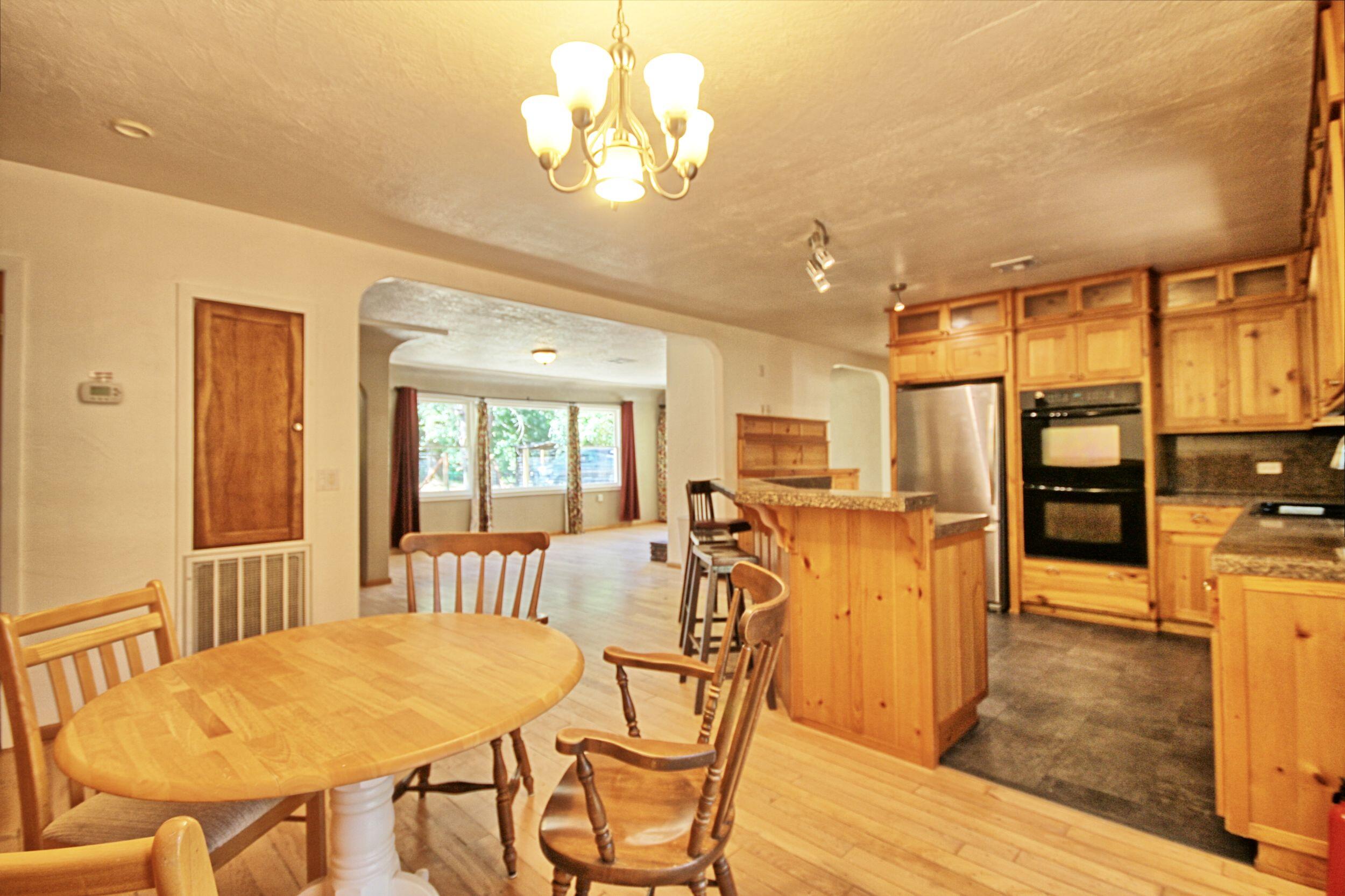 199 Powell Creek Road Williams, OR 97544 - Photo 20 of 57 a view of a dining room with furniture and wooden floor