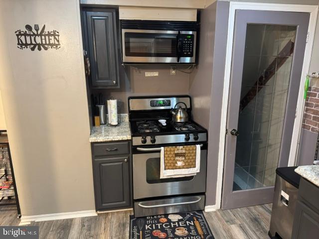 4603 Raleigh Road Temple Hills, MD 20748 - Photo 8 of 40 a kitchen with stainless steel appliances granite countertop a stove and a microwave