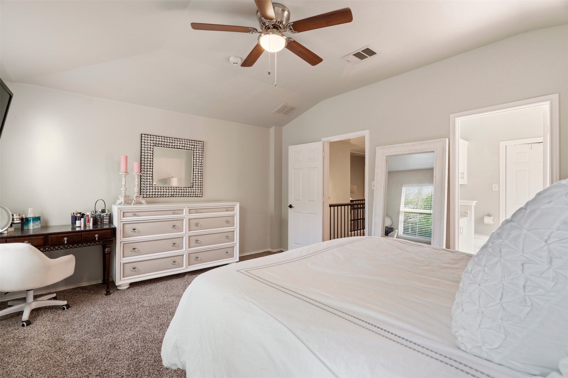 913 Bogart Road Cedar Park, TX 78613 - Photo 12 of 27 Bedroom with dark colored carpet, vaulted ceiling, ceiling fan, and ensuite bathroom