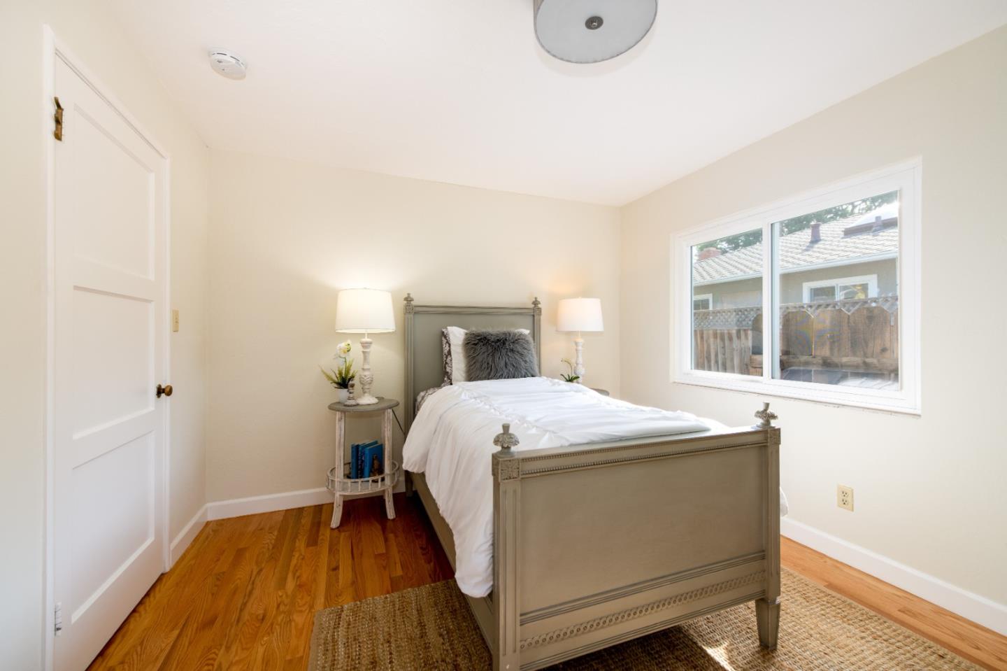 250 Vincent Drive Mountain View, CA 94041 - Photo 12 of 23 a bedroom with a bed and wooden floor