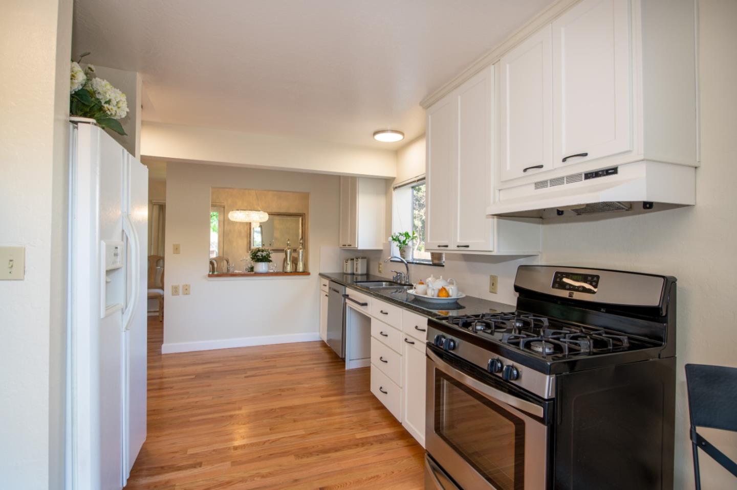 250 Vincent Drive Mountain View, CA 94041 - Photo 8 of 23 a kitchen with stainless steel appliances a stove a sink and a refrigerator