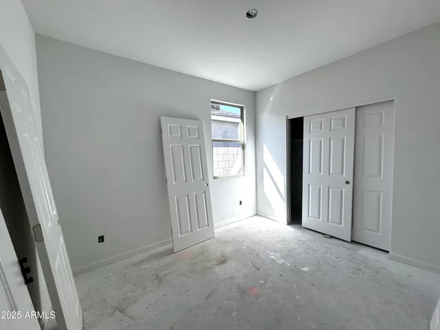 a view of a livingroom with an empty space and a window