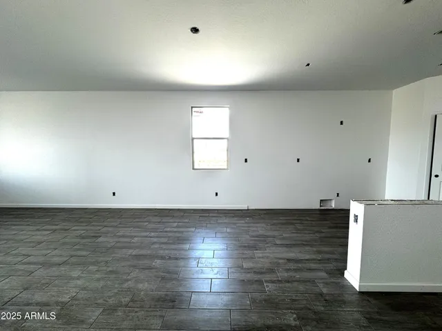 a view of a room with wooden floor and window