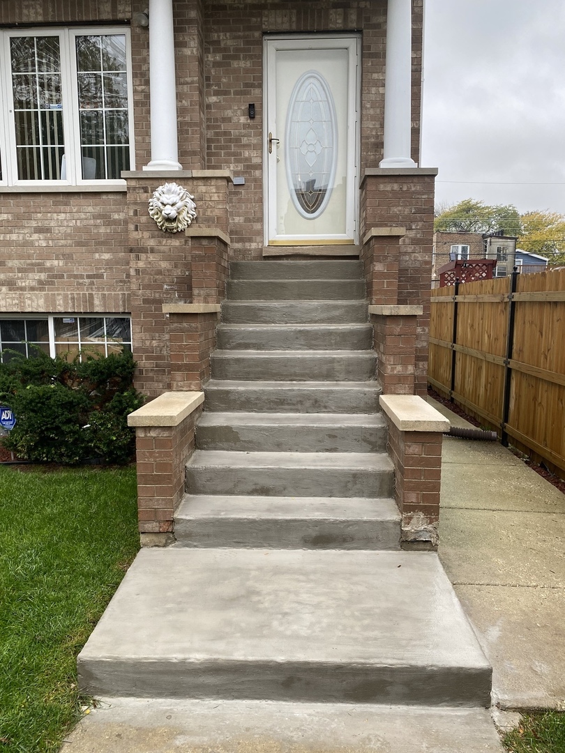 922 North Springfield Avenue Chicago, IL 60651 - Photo 2 of 47 a view of a house with door and wooden fence
