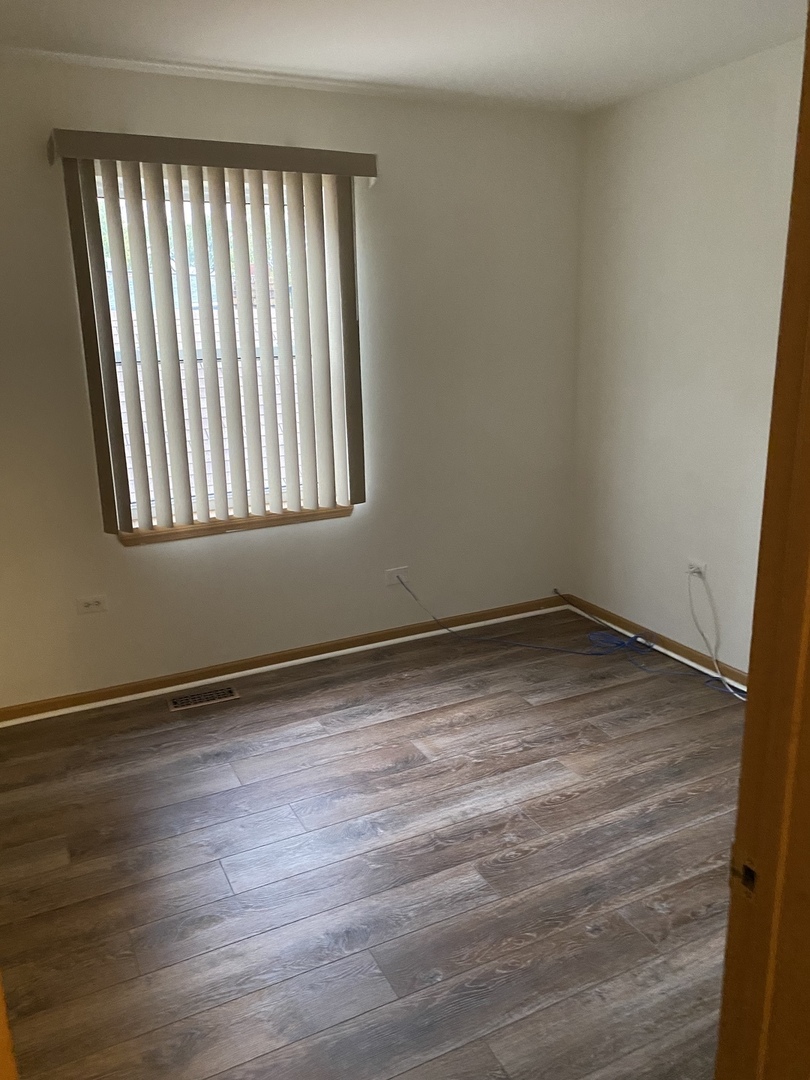 922 North Springfield Avenue Chicago, IL 60651 - Photo 21 of 47 a view of an empty room with wooden floor and a window