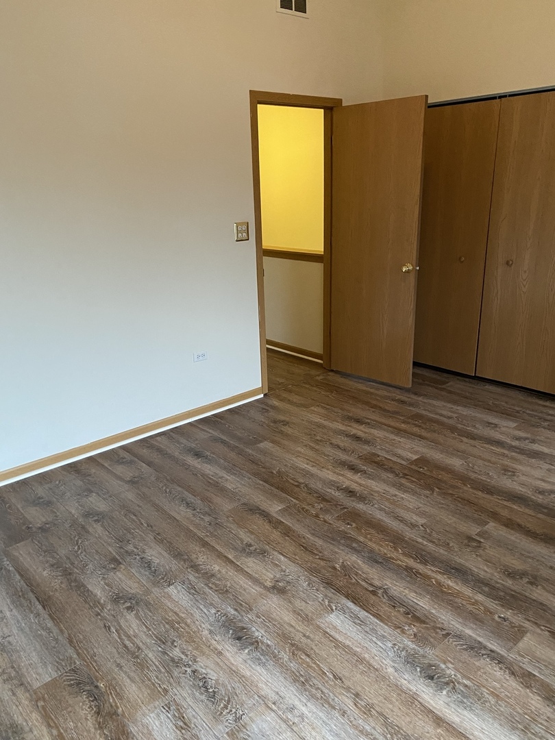 922 North Springfield Avenue Chicago, IL 60651 - Photo 29 of 47 a view of an empty room with wooden floor and a window