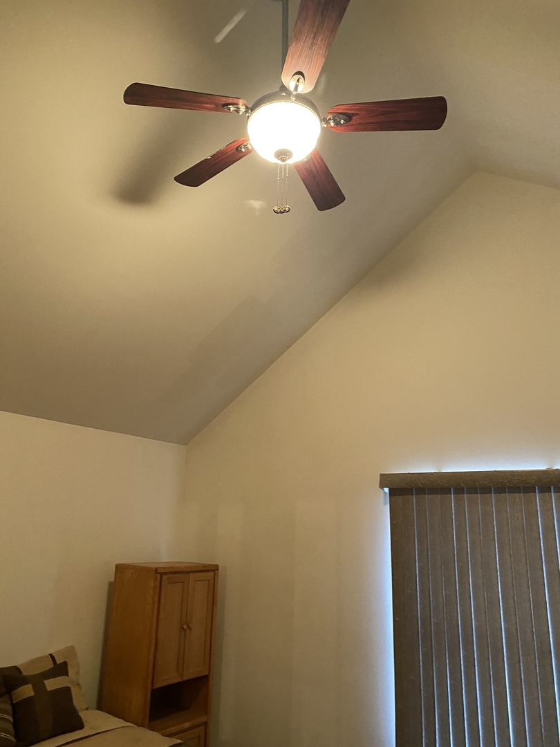 922 North Springfield Avenue Chicago, IL 60651 - Photo 31 of 47 a bedroom with a bed and a chandelier