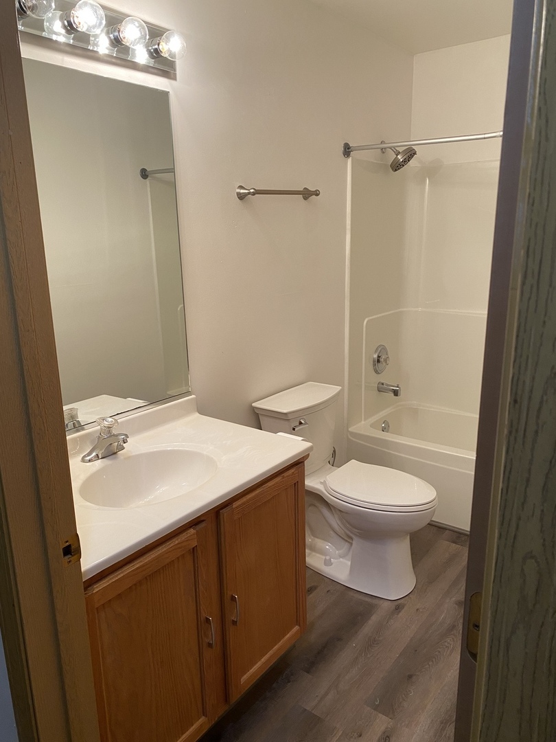 922 North Springfield Avenue Chicago, IL 60651 - Photo 33 of 47 a bathroom with a toilet a sink and shower