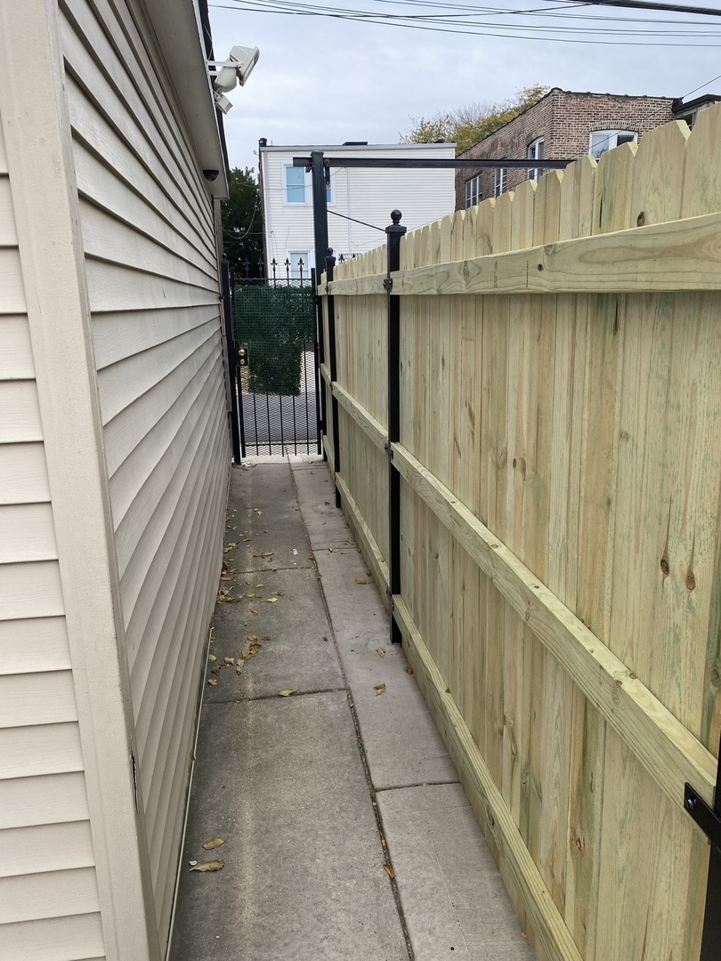 922 North Springfield Avenue Chicago, IL 60651 - Photo 38 of 47 a view of a balcony with wooden floor and fence