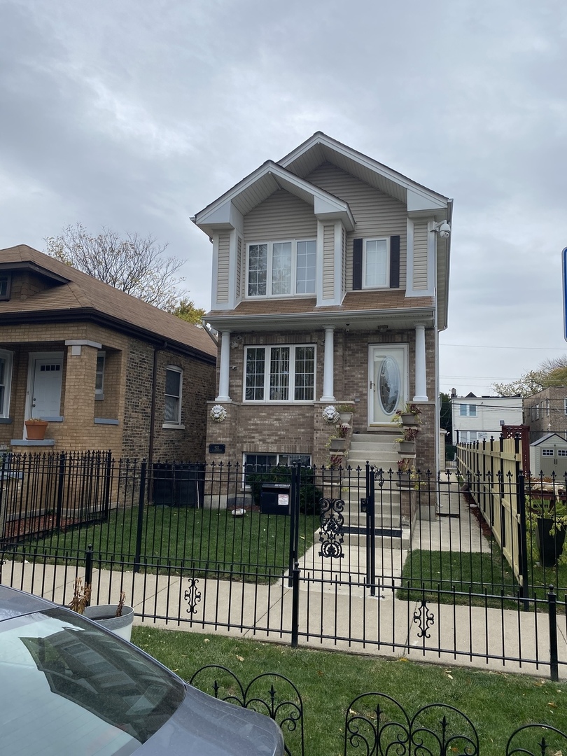 922 North Springfield Avenue Chicago, IL 60651 - Photo 42 of 47 a front view of a house with a garden