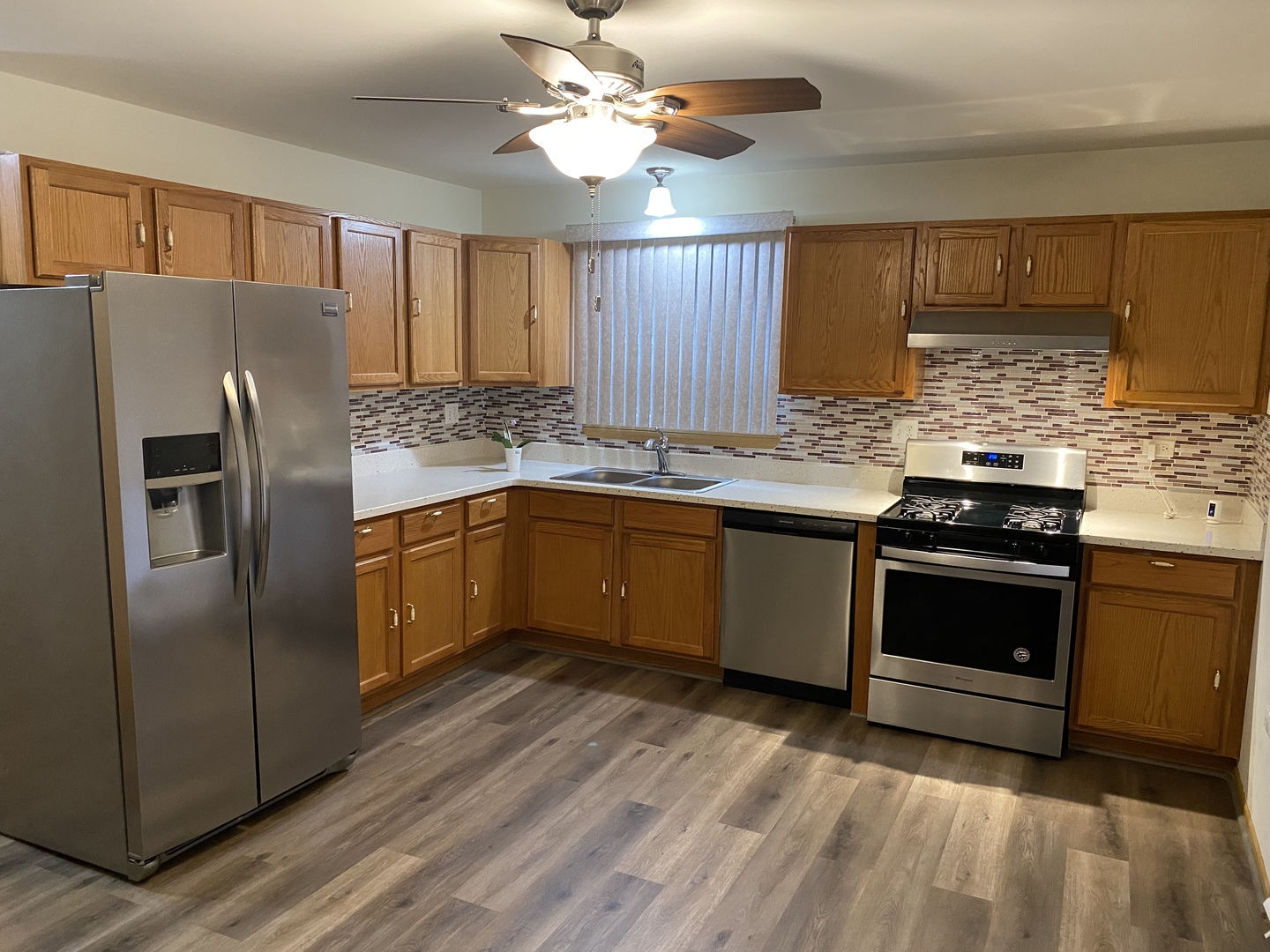 922 North Springfield Avenue Chicago, IL 60651 - Photo 6 of 47 a kitchen with stainless steel appliances kitchen island granite countertop a stove a sink dishwasher and a refrigerator