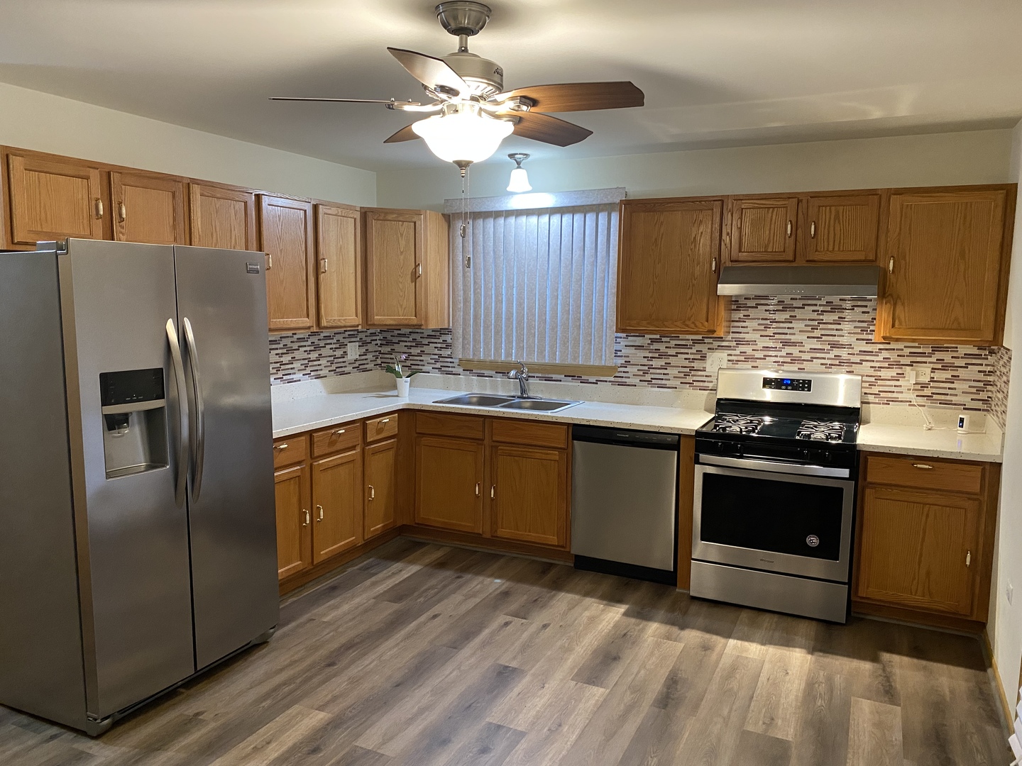 922 North Springfield Avenue Chicago, IL 60651 - Photo 10 of 47 a kitchen with stainless steel appliances granite countertop a stove a refrigerator and a sink